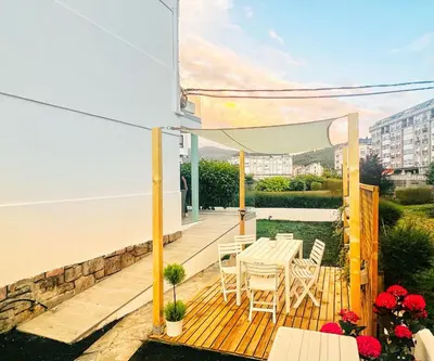 a patio with a table and chairs on a deck at Villa Turquesa B in Viveiro