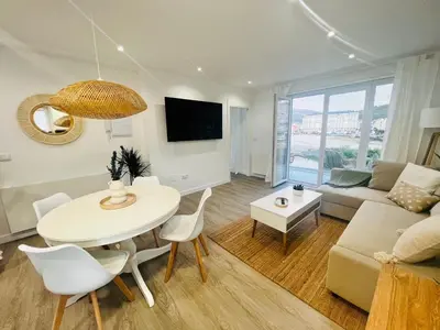 a living room with a table and a couch at Villa Turquesa B in Viveiro