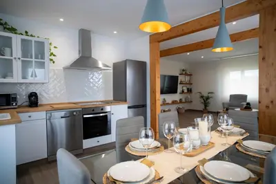 a kitchen with a table with wine glasses on it at As Lavandas, Sober in Lobios