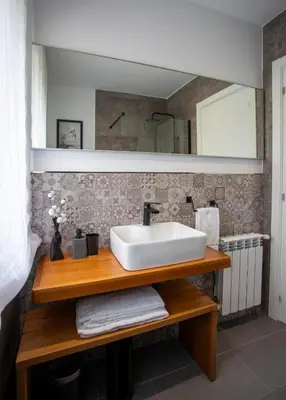 a bathroom with a sink and a mirror at As Lavandas, Sober in Lobios