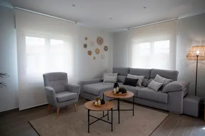 a living room with a couch and two chairs and a table at As Lavandas, Sober in Lobios
