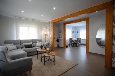a living room with a couch and a table at As Lavandas, Sober in Lobios