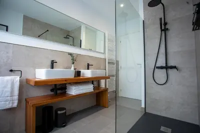 a bathroom with two sinks and a shower at As Lavandas, Sober in Lobios