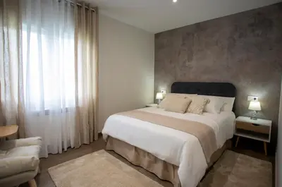 a bedroom with a large bed and a large window at As Lavandas, Sober in Lobios