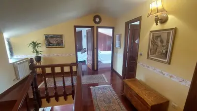 a bathroom with a sink and a toilet and a mirror at Casa Kamelias in Moraña