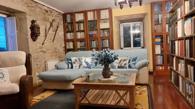 a small bedroom with a bed and a window at Casa Kamelias in Moraña