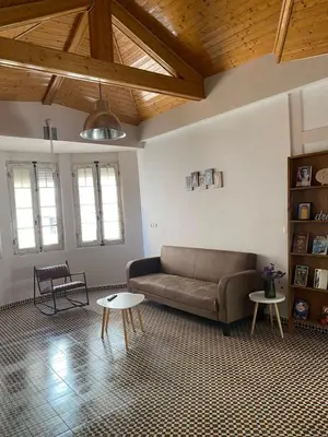 a living room with a couch and two tables at Cuarto Antolín Yellowdoor in Ponferrada