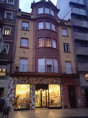 a tall building with a balcony on top of it at Cuarto Antolín Yellowdoor in Ponferrada