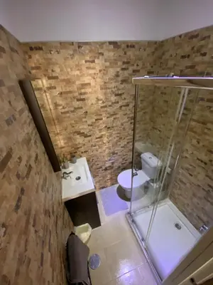 a bathroom with a glass shower and a toilet at Cuarto Antolín Yellowdoor in Ponferrada