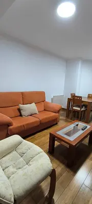 a living room with a couch and a coffee table at Apartamento A Cañiza in La Cañiza