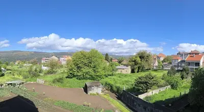 a view of a village with houses and trees at Apartamento A Cañiza in La Cañiza
