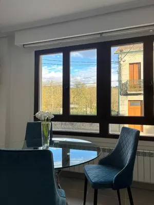 a dining room with a glass table and two chairs at Piso Carballal, Fantástico piso en pleno centro in Leiro