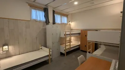 a room with two bunk beds and a table at Calm Stay in Teo