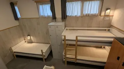 a small room with two bunk beds in it at Calm Stay in Teo