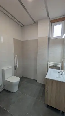 a bathroom with a toilet and a sink at Calm Stay in Teo