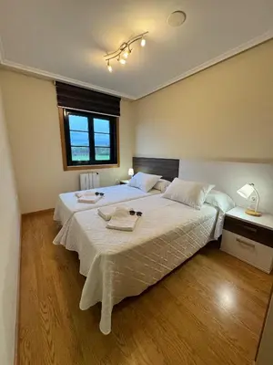 a bedroom with a large bed and a window at Apartamento Océano VI in Villadaíde