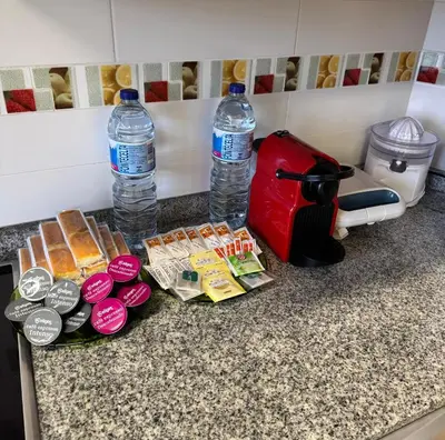 a counter top with two bottles of water and food at Apartamento Océano VI in Villadaíde