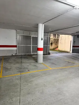 an empty parking garage with a white pole in it at Apartamento Océano VI in Villadaíde