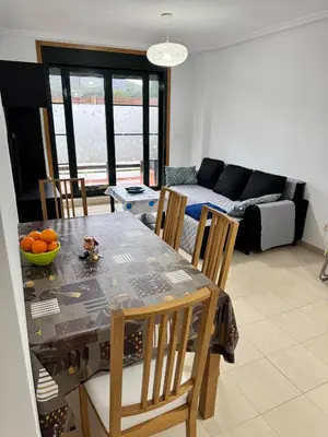 a living room with a table and chairs and a couch at Apartamento Herosa 2 Spa in San Miguel de Reinante