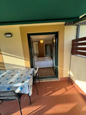 a balcony with a table and a bed in a room at Apartamento Herosa 2 Spa in San Miguel de Reinante