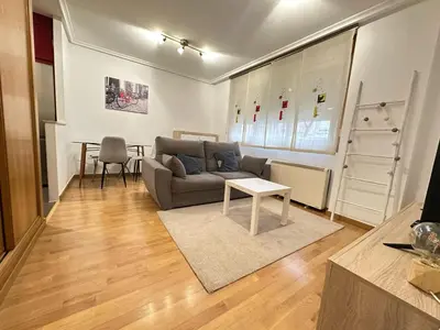 a living room with a couch and a table at Termas de Ourense in Ourense