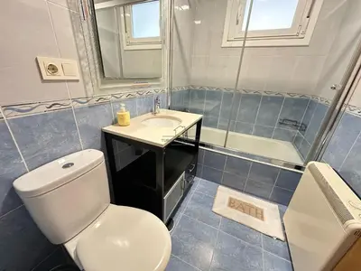 a bathroom with a toilet and a sink and a shower at Termas de Ourense in Ourense
