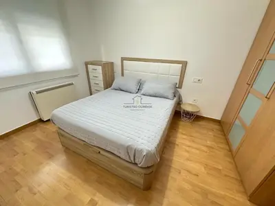 a bedroom with a bed with a candle on it at Termas de Ourense in Ourense