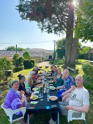 a group of people sitting around a long table at A casa de Carmen in Sarria
