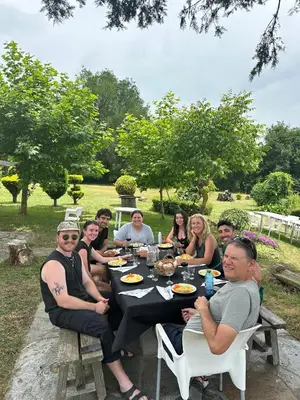 a group of people sitting around a table eating at A casa de Carmen in Sarria
