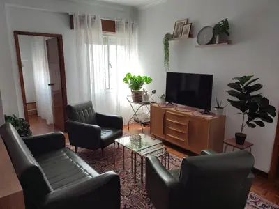 a living room with chairs and a flat screen tv at Piso Fenuca in Ourense