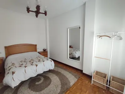 a bedroom with a bed and a mirror at Piso Fenuca in Ourense