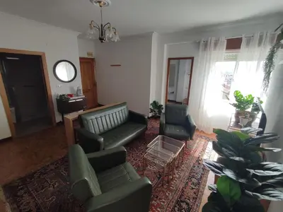 a living room with a couch and chairs and a table at Piso Fenuca in Ourense