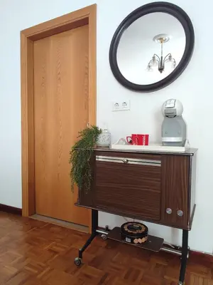 a mirror on the wall next to a dresser with a mirror at Piso Fenuca in Ourense
