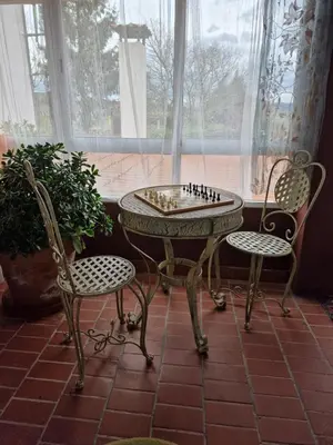a table with a chess board on it next to two chairs at Piso vacacional en Casa Carroucha in Valga