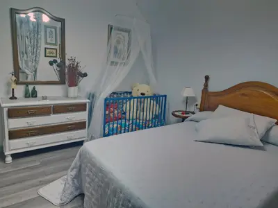 a bedroom with a bed and a dresser with a mirror at Piso vacacional en Casa Carroucha in Valga