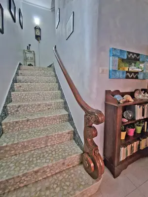a staircase in a home with a wooden stair case at Piso vacacional en Casa Carroucha in Valga