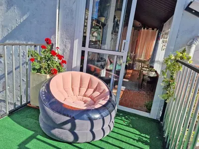 a chair sitting on the front porch of a house at Piso vacacional en Casa Carroucha in Valga