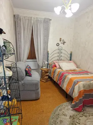 a bedroom with a bed and a couch and a chair at Piso vacacional en Casa Carroucha in Valga