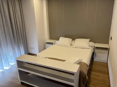 a small bedroom with a bed with white sheets and pillows at As Mirandas Apartment in Ares