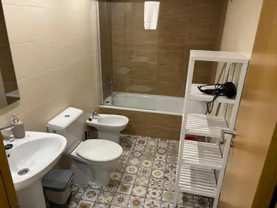 a small bathroom with a toilet and a sink at As Mirandas Apartment in Ares