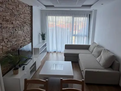 a living room with a couch and a table at As Mirandas Apartment in Ares