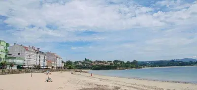 a sandy beach with buildings and the ocean and a city at As Mirandas Apartment in Ares