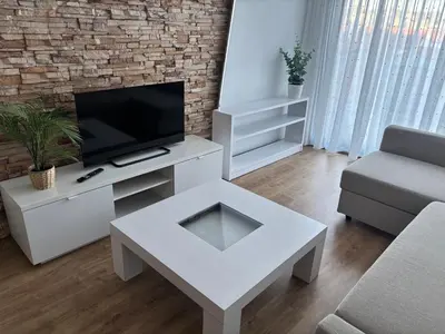a living room with a tv and a white coffee table at As Mirandas Apartment in Ares