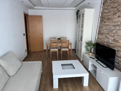 a living room with a couch and a table at As Mirandas Apartment in Ares