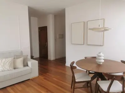 a living room with a white couch and a table at Apartamento AIIA in Ribadeo