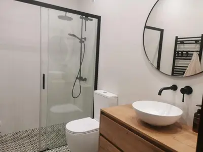a bathroom with a toilet and a sink and a mirror at Apartamento AIIA in Ribadeo