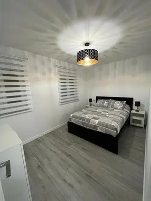 a bedroom with a bed and a chandelier at Vivienda turística Ares in Ares