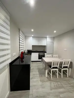 a large kitchen with a table and chairs in it at Vivienda turística Ares in Ares
