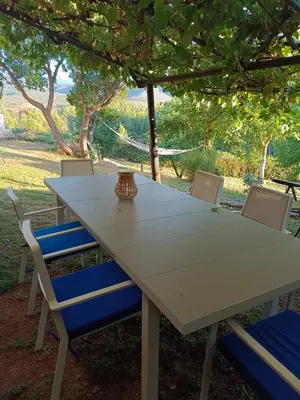 a white table with chairs and a vase on it at Casa Macías in Lago de Carucedo