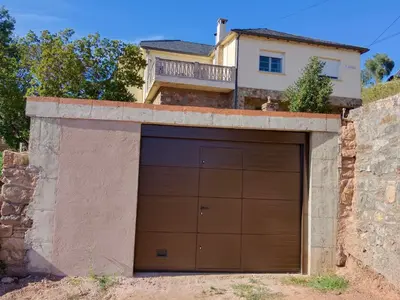a garage door in front of a house at Casa Macías in Lago de Carucedo